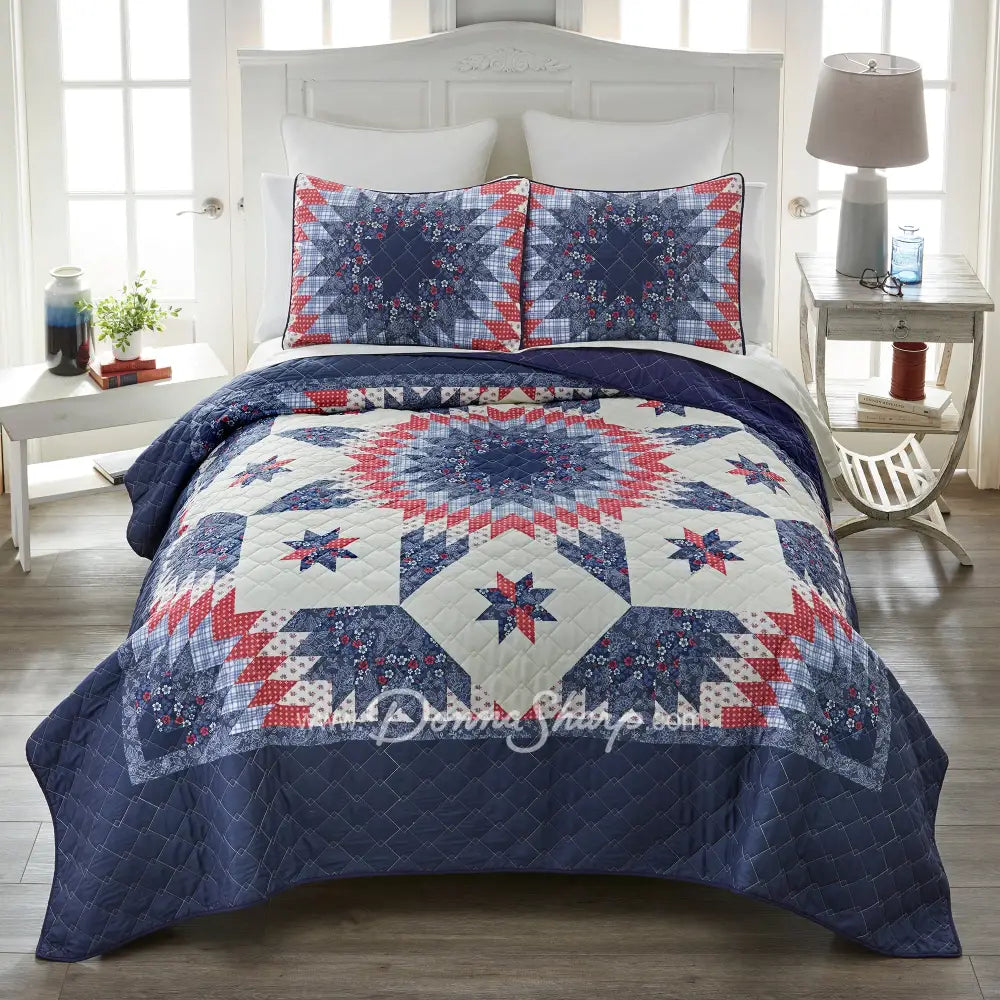 Donna Sharp Bluefield Star quilt set styled on bed with navy floral border, country blue, periwinkle, pale ivory, rose, and raspberry Lone Star pattern, and matching pillow shams