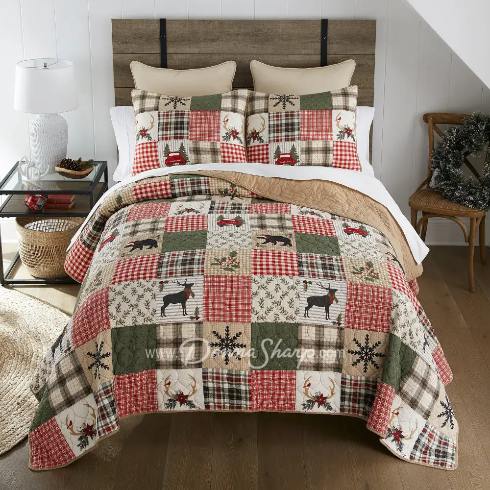 Holly Forest Cotton Pieced Quilt Set Holiday themed bedding adorned with deer, red trucks, and Christmas decor with plaid reverses to tan color