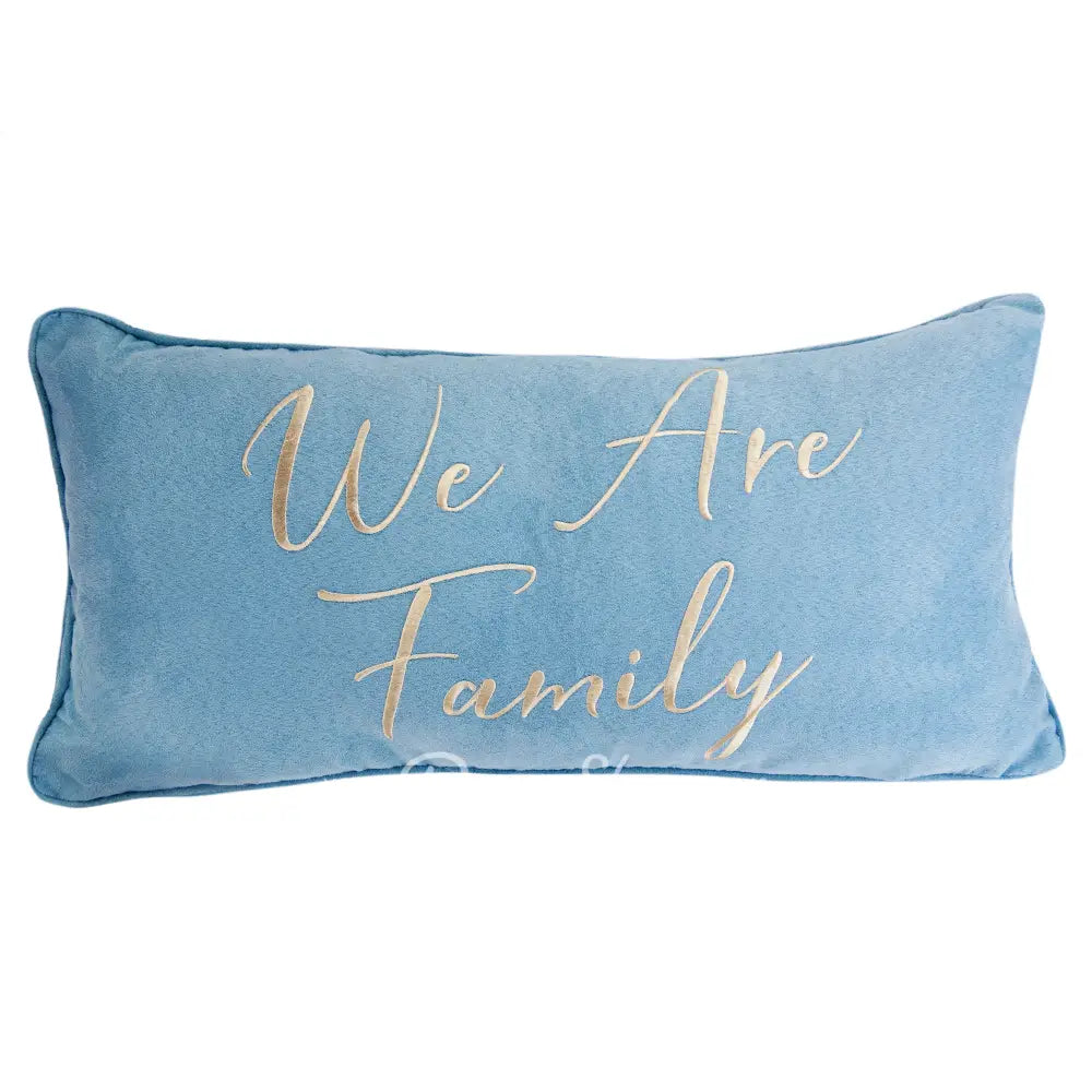 Blue pillow with 'We Are Family' text in gold on a white background