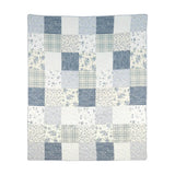 Donna Sharp Blue Pastures cotton patchwork throw blanket in soft blues, gentle creams, and crisp whites with floral, plaid, script and rose fabric blocks