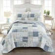 Donna Sharp Blue Pastures cotton patchwork quilt set styled on bed in coastal farmhouse bedroom with soft blues, gentle creams, and crisp white floral and plaid blocks
