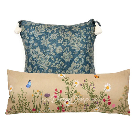 Donna Sharp Two-Piece Floral Pillow Set rectangle with wildflowers and butterflies on a tan background and square floral on a blue background with tassels.