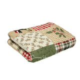 Holly Forest Cotton holiday themed quilted throw folded shows holly designs and plaid