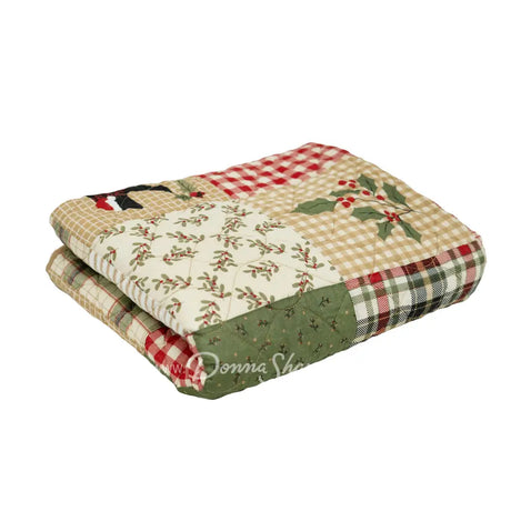 Holly Forest Cotton holiday themed quilted throw folded shows holly designs and plaid