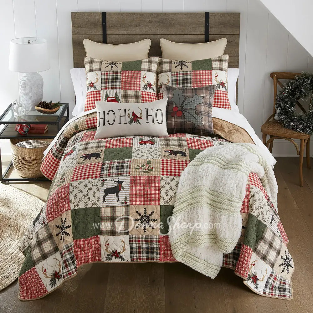Holly Forest Cotton Pieced Quilt Set King Set Holiday themed bedding with decorative pillows and throw blanket on bed